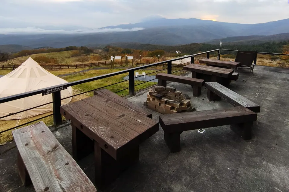 The deck: fire pit, benches, a reclining chair and the view